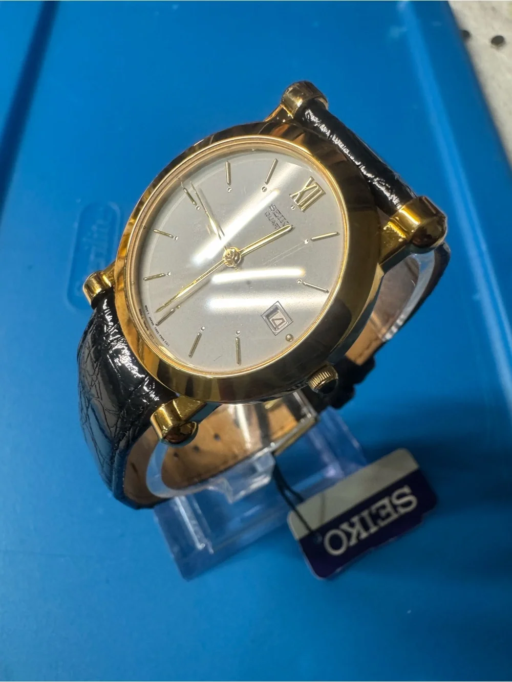 Seiko Gold Tone Watch with White Dial and Black Strap